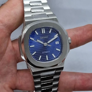 Nautilus Blue Dial Mod - Denna klocka är en modifiering.  Varje del är ny.  Info om boetten:  Diameter: 41mm Blå urtavla med luminiscens. Tim och minutvisare är lysande.  Klockan har Safirglas.   Info om urverket: Seiko Nh35 (automatisk)  Hör av dig vid frågor o funderingar!