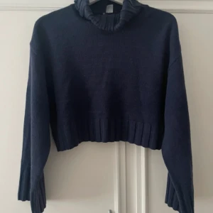 Stickad tröja  - Mörkblå stickad tröja som är lite croppad, knappt använd och är i väldigt bra skick 