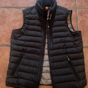 Svart dunväst från Parajumpers - Säljer en svart dunväst från Pjs i storlek M. Västen är i nyskick.