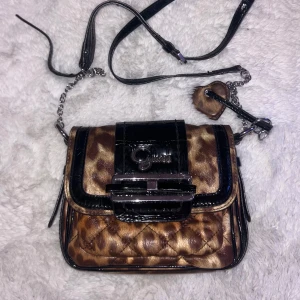 Guess väska med leopardprint - Säljer denna otroligt snygga och trendiga väska från GUESS med leopardmönster!! Säljer då den tyvärr inte kommer till användning längre. Använts 2-3 gånger, har inga defekter och är i mycket bra skick!! 💕 Skriv innan köp och för frågor :) Köparen står för frakten!! (orginalpris ≈ 1650kr)