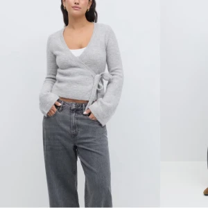 Grå omlottkofta från Gina - OPS, SÄLJER I SVART. Använd ca 1-2 gånger därmed fint skick.                              Snygg grå omlottkofta från Gina i mjukt material. Koftan har långa ärmar och en knytning i sidan som ger en stilren look. Perfekt för lager-på-lager under kyligare dagar.