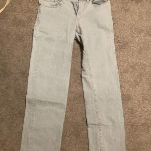 Säljer ett par ljusblå jeans med klassisk femficksdesign från H&M. Byxorna är i regular fit och är perfekta för en avslappnad stil. De har en dragkedja och knapp framtill.        Storlek: 29/32