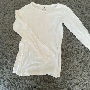 Vit långärmad tröja från H&M - Säljer en enkel och stilren vit långärmad tröja från H&M. Perfekt basplagg som passar till allt! Tröjan är i bomull och har en normal passform. Perfekt för både vardag och fest. Köp direkt eller ge prisförslag 💛