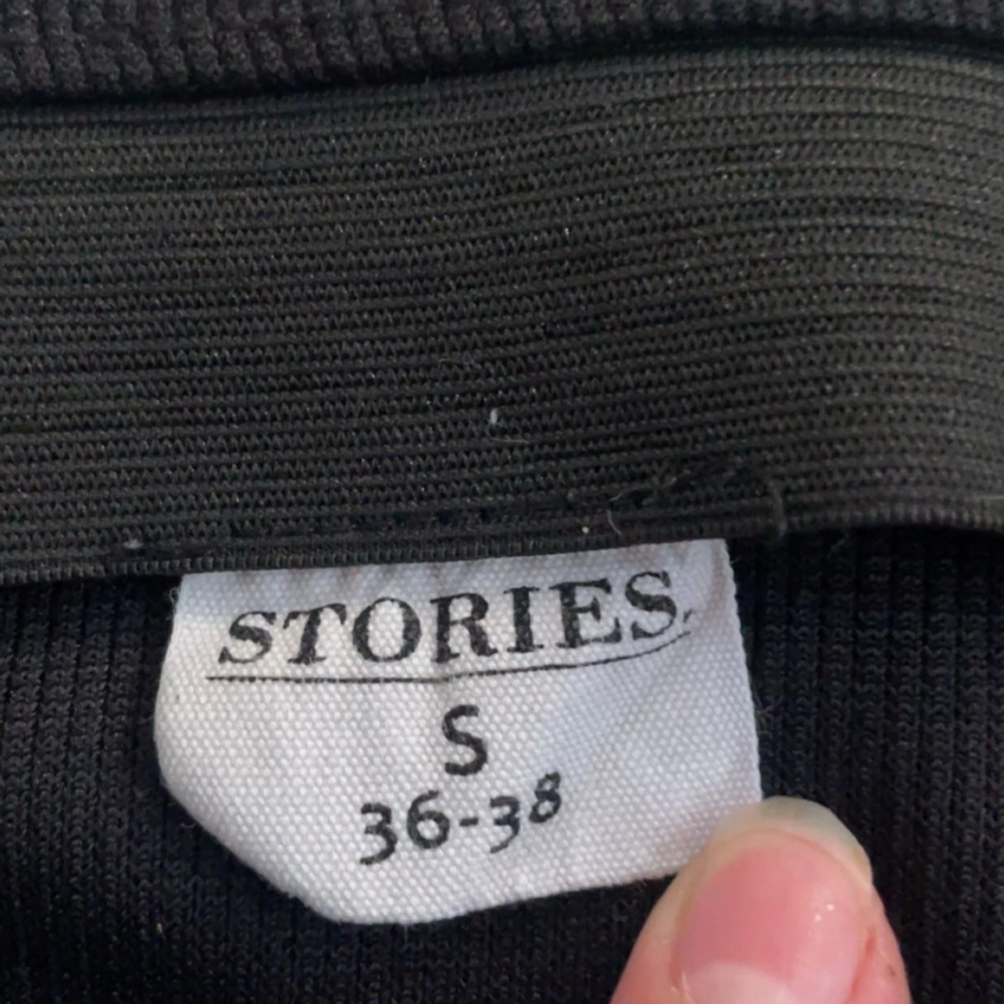 En svart ribbad kort-kjol med slits  - 90