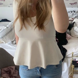 Peplum topp - Säljer denna finna topp med urringning och volang nedtill från Kappahl. Den har några små fläckar vid volangen, knappt synliga (bild 3), annars superfint skick💕