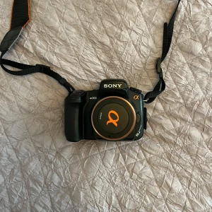 Sony kamera & objektiv  - Modell: Sony Alfa 300 DSLR-A-300 kamera + Sigma 18-200 mm objektiv.  Mycket fin kamera, aldrig använd av mig och knappt använd av förra ägaren. Säljer pågrund av att den inte kommer till användning 🤗 Kommer i orginalförpacking, batteriladdare & kameraväska medföljer. Pris går att diskuteras 💕