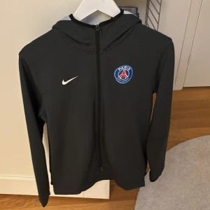 Svart hoodie med Paris-logga - Säljer en svart hoodie från Nike med Paris-logga på, passar s-m