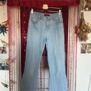 Ljusblå randiga jeans  - Säljer ett par ljusblå jeans. Jättefina jeans med lite y2k känsla! Aldrig använda då de är för korta på mig (testade även att sprätta upp sömmen längst ner som ni kan se på bilden) Står storlek 30, och här har ni måtten :) Midjemått: 33cm Innerbenslängd: 64cm   Pris kan diskuteras vid köp av fler artiklar! Har fler jeans osv på min sida