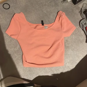 Persikofärgad topp  - Säljer en söt topp, as snygg till kostymbyxor till fina tillfällen osv, urringad, går även att bära till vardags. 