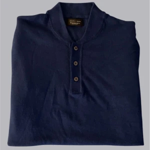 Mörkblå kortärmad tröja från Zara Man - Säljer en stilren mörkblå tröja från Zara Man. Tröjan har korta ärmar och tre knappar framtill. Perfekt för en avslappnad men ändå snygg look.