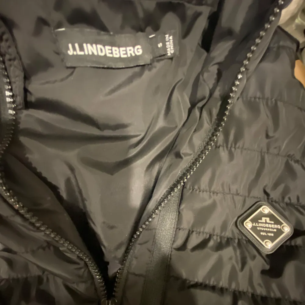 Snygg svart hybridjacka från J.Lindeberg med quiltad design och huva. Slutsåld nästan överallt och är väldigt svårt att hitta. Mycket bra skick och är perfekt till våren. Original priset på jackan var 3200kr. . Takit.
