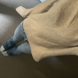 Beige stickad tröja  - Mysig beige stickad tröja med lång ärm och avslappnad passform. Tröjan har breda ribbade muddar vid ärmslut och nederkant, perfekt för lager-på-lager och chill dagar. Enkel och stilren design som funkar till det mesta.