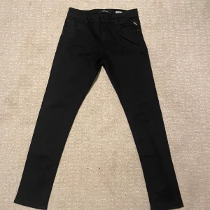 Svarta Replay MickyM jeans slim tapered 31/34 - Säljer nu dessa Svarta jeans från Replay. Modellen är slim tapered fit. Dom är i bra skick och andvända fåtal gånger. Ny pris ca 1250kr. Vid minsta lilla fundering är de bara att höra av sig.
