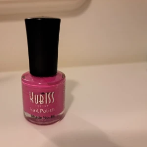 Kubiss rosa nagellack Shade 66 - Kubiss London Nail Polish i nyansen Shade No. 66 är ett intensivt rosa nagellack med glansig finish. Kommer i en rund glasflaska med svart plastlock. Perfekt för dig som vill ha färgstarka naglar och sticka ut med en poppig look.