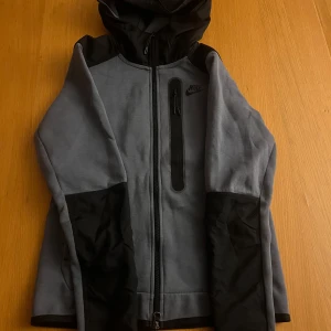 Nike tech fleece - Hej säljer min Nike tech, den är sparsamt använd och är i 8/10 skick, den har en liten fläck på framsidan som knappt syns, den ska gå att få bort i tvätten. Den är i storlek xs men passar också S. Skriv för mer info🤩