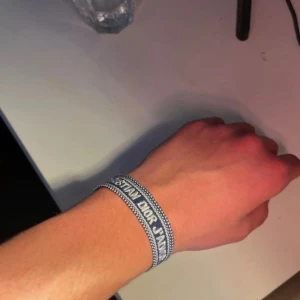 Dior armband - Helt ny inte använd, passar fint nu till sommaren. Perfekt material och justerbar för den är No size. Tyg!