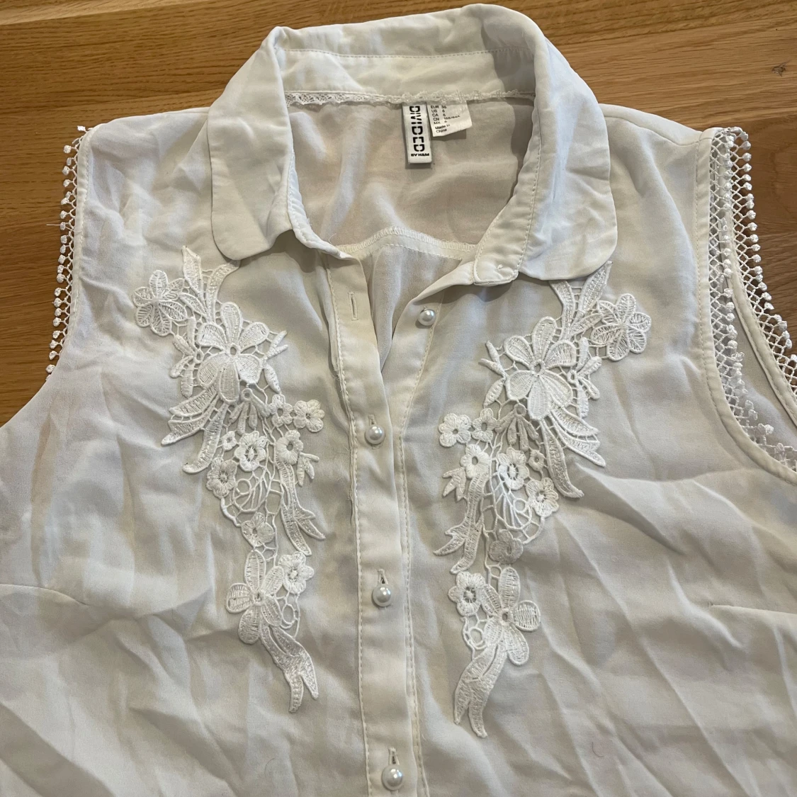 Vit ärmlös blus med spetsdetaljer från Divided - 1