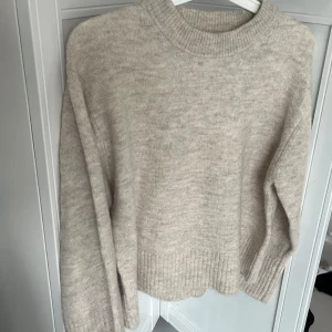 Beige stickad tröja  - Mysig beige stickad tröja med rund hals och långa ärmar. Tröjan har ribbade muddar vid ärmslut och nederkant. Enkel och stilren design som passar till det mesta. Storlek 146/152 men skulle mer säga att den är som en eller två storlekar över det, passar en xs-s💓Aldrig använd 💓