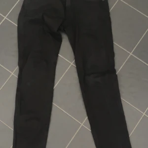 Replay Anbass - Ett par svarta Replay Anbass jeans i storlek 28:32, Jeansen är använda ca 3 ggr och är i perfekt skick. Säljer jeansen eftersom att jag beställde en storlek för liten och inte använder längre! Köpta för 1399 på NK. Om du har funderingar så kan du skriva, kan tänka mig att sänka priset vid snabb affär!