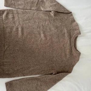 Beige stickad tröja i lammull - Mysig beige stickad tröja i lammullsmix från Cubus. 