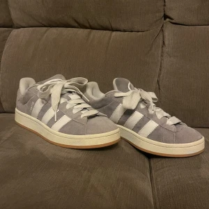 Gråa campus  - Säljer ett par adidas campus i grå. Tillverkade i mocka och skulle säga att skicket är mycket bra, skorna är använda men inga synliga skador eller annat. Skriv privat vid fler frågor eller funderingar. Pris går att diskutera (skokartong finns ej) 