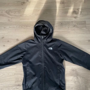Svart regnjacka från The North Face - Svart North Face jacka i stl S, sitter som en medium. Cond 9/10. Riktigt snygg jacka i övrigt och i regnet så uppfyller den sin uppgift till 110%. Tveka inte på höra av dig vid minsta lilla fundering.