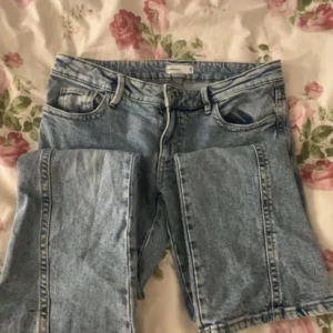 Lågmidjade jeans  - Säljer ett par klassiska blå jeans från Perfect Jeans. De har en snygg broderad detalj på bakfickorna och en knappgylf. Perfekta för en avslappnad stil.