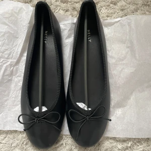 Svarta ballerinaskor från Nelly - Snygga svarta ballerinaskor från Nelly. Dom är helt oanvända och säljer för att dom inte passade. Det är storlek 40 (kanske en aning små i storleken). Supersnygga nu till våren och sommaren. 🥰