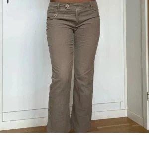 Beige manchesterbyxor/kostybyxor 🥰 - Snygga beige manchesterbyxor med bootcut-stil och låg midja. Byxorna har dekorativa knappar framtill och en klassisk passform🙌🏼 St 36 och dom är från Kappahl 🙂Skriv för fler bilder på byxorna