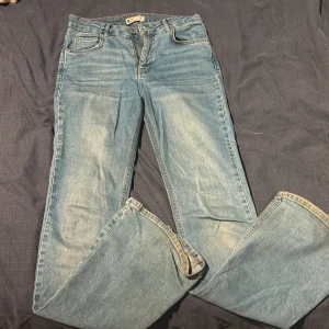 Ljusblå jeans med bootcut - Jeans i ljusblå tvätt med bootcut ben och femficksmodell. Perfekta för en avslappnad och tidlös stil.