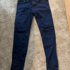 Mörkblå tapered jeans från Bison - Snygga mörkblå jeans från Bison i tapered fit med klassisk femficksdesign och kopparfärgade nitar. Jeansen har normal midja och är tillverkade i ett mjukt bomullstyg med lite stretch för extra komfort. Perfekta för dig som gillar en smalare passform utan att de sitter för tight. Org pris 999kr köpt på Wagner. Använda max 10 ggr. Och tvättade 3 gånger typ.