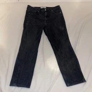 Svarta slim jeans från H&M - Snygga svarta slim jeans från H&M, tillverkade med Circulose® denim. Perfekta för en stilren look med klassisk femficksdesign och knappgylf. Litet hål se bild 4