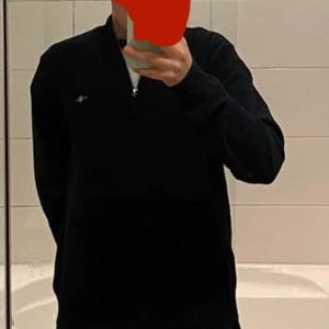 Svart tröja med dragkedja från GANT - Säljer en stilren svart tröja från GANT med dragkedja och ribbade detaljer vid kragen. Perfekt för en avslappnad och snygg look. Tröjan har långa ärmar och en liten logotyp på bröstet.SÄLJER FÖR EXTREMT BRA PRIS JÄMFÖR MED NY PRIS!!!!!