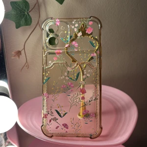 Transparent mobilskal med blommönster - Snyggt transparent mobilskal med ett vackert blommönster i rosa och grönt. Skalet har en praktisk kort hållare.