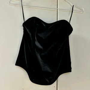 Svart sammetstopp från BikBok - Snygg svart sammetstopp från BikBok (banden som man ser på bilderna är inte axelband)⭐️. Perfekt för en kväll ute eller en speciell tillställning. Toppen har en elegant och stilren design som ger en lyxig känsla.