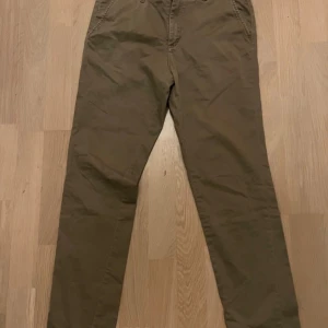 Bruna chinos - Snygga bruna chinos med normal passform från Jack & Jones. Perfekta för en stilren look. De har en klassisk design med fickor fram och bak.