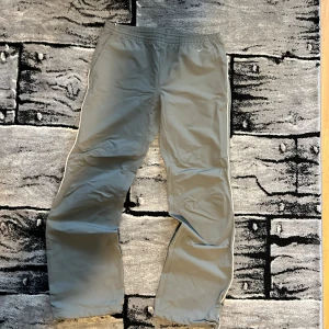 Grå Nike träningsbyxor  - Grå vintage Nike byxor med elastisk midja och dragkedja på bakfickan. Den har vida ben och inga lappar. Pris kan diskuteras vid snabb affär. Efterliknar en storlek S. DM vid eventuella mått. 