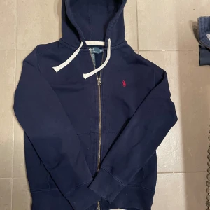 Ralph lauren hoodie  - En schyst Ralph lauren hoodie med snören. Passar perfekt till nästan allt😁Skick 9/10 dragkedjan kan krångla lite. Fråga gärna vid minsta fundering 🤔 Priset kan diskuteras✅