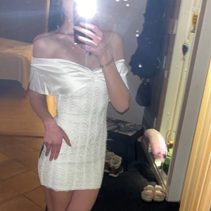 Vit offshoulder klänning - Säljer en elegant vit offshoulder klänning. Klänningen är kort och har en snygg passform som framhäver figuren. Perfekt till studenten! Klänningen är aldrig använd då den är lite för tajt för mig och därav säljer jag den. Lappen sitter även kvar. Den är inköpt för 799kr 