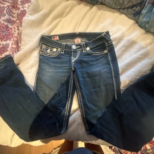 Mörkblå jeans från True Religion - Snygga mörkblå jeans från True Religion med kontrasterande vita sömmar och dekorativa fickor. Jättesnygga och passar till allt. Super kvalite❤️
