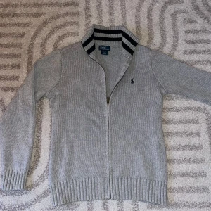 Grå kofta från Polo Ralph Lauren - Säljer denna kofta från Ralph Lauren. Köpte den för ca 2 månader sen men den va för kort för mig som 174. Den är alltså i riktigt bra skick. Kontakta för fler frågor👌