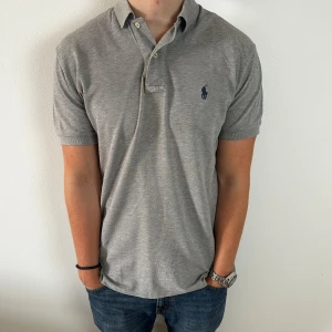 Ralph lauren piké | S - Grå Ralph Lauren piké | fint skick | äldre modell, tröjan är något längre baktill | modellen är ca 180 |  hör av dig om du har funderingar🙌|