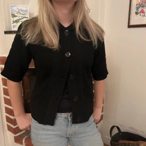 Svart stickad kofta med kort ärm och stora knappar - Svart stickad kofta med korta ärmar och knappar framtill🥰köpt second hand