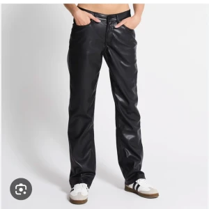 Svarta skinnbyxor - Snygga svarta skinnbyxor med en rak passform. Byxorna har en klassisk design med dragkedja och knapp framtill. Perfekta för en stilren look, aldrig använda , endast testade. Nypris 300🩷🩷