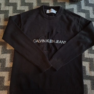 Calin Klein tröja - Svart stickad tröja från Calvin Klein 🩶  🧐Tröjan är har lite urtvättad men det ger den en lite snyggare still, den har inga defekter och passar L/M  Skick: Mycket bra👌 Storlek: M/L  Mått(ca)📐📏: Längd: 72cm Bröst: 55cm Midja:55cm Axelbredd: 51cm Arm(från axeln): 59cm  Material♻️🌿: 100%bomull  📍Tveka inte på att ställa frågor eller sätta bud  #calvinklein #jumper #stickadtröja #tröjor #ck #ckjumper #crewneck