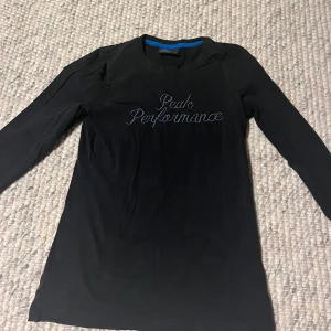 Svart långärmad tröja från Peak Performance - Säljer en svart långärmad tröja från Peak Performance med rund halsringning och broderad logga framtill. Perfekt baströja med enkel och stilren design. Passar till många olika outfits.