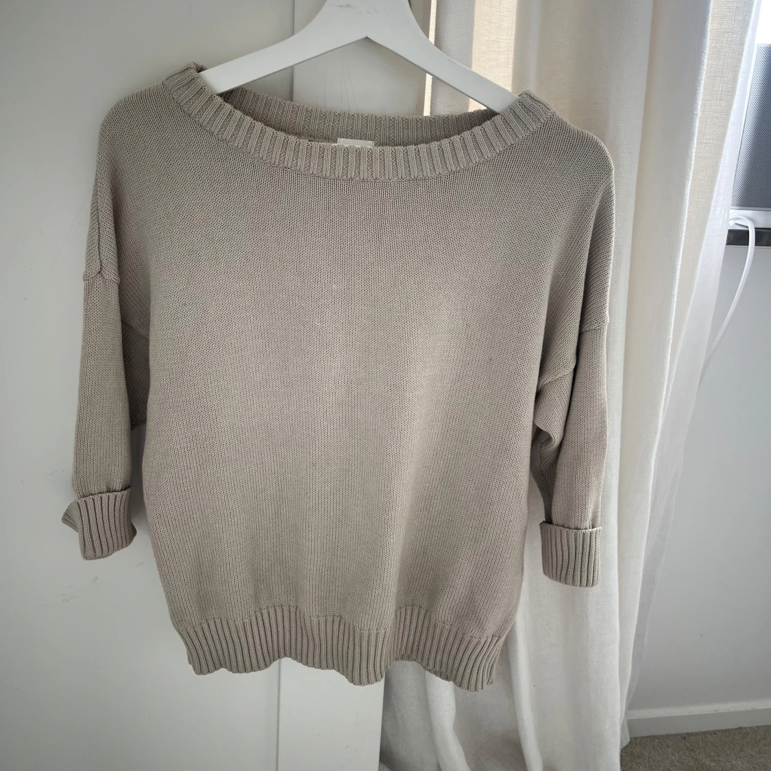 Beige stickad tröja med bred halsringning