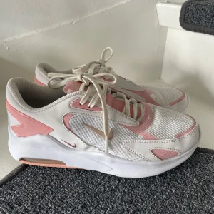 Nike Air Max sneakers i vitt och rosa - Snygga Nike Air Max sneakers i vitt med rosa detaljer och mesh-överdel. Sparsamt använda så i väldigt fint skick.
