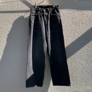 Gråa loose fit jeans från Weekday - Säljer ett par gråa jeans från Weekday i modellen Astro Loose Baggy Jeans. Byxorna har knappar i gylfen, raka ben och klassisk femficksdesign. Storlek W27/L32. Knappt använda.