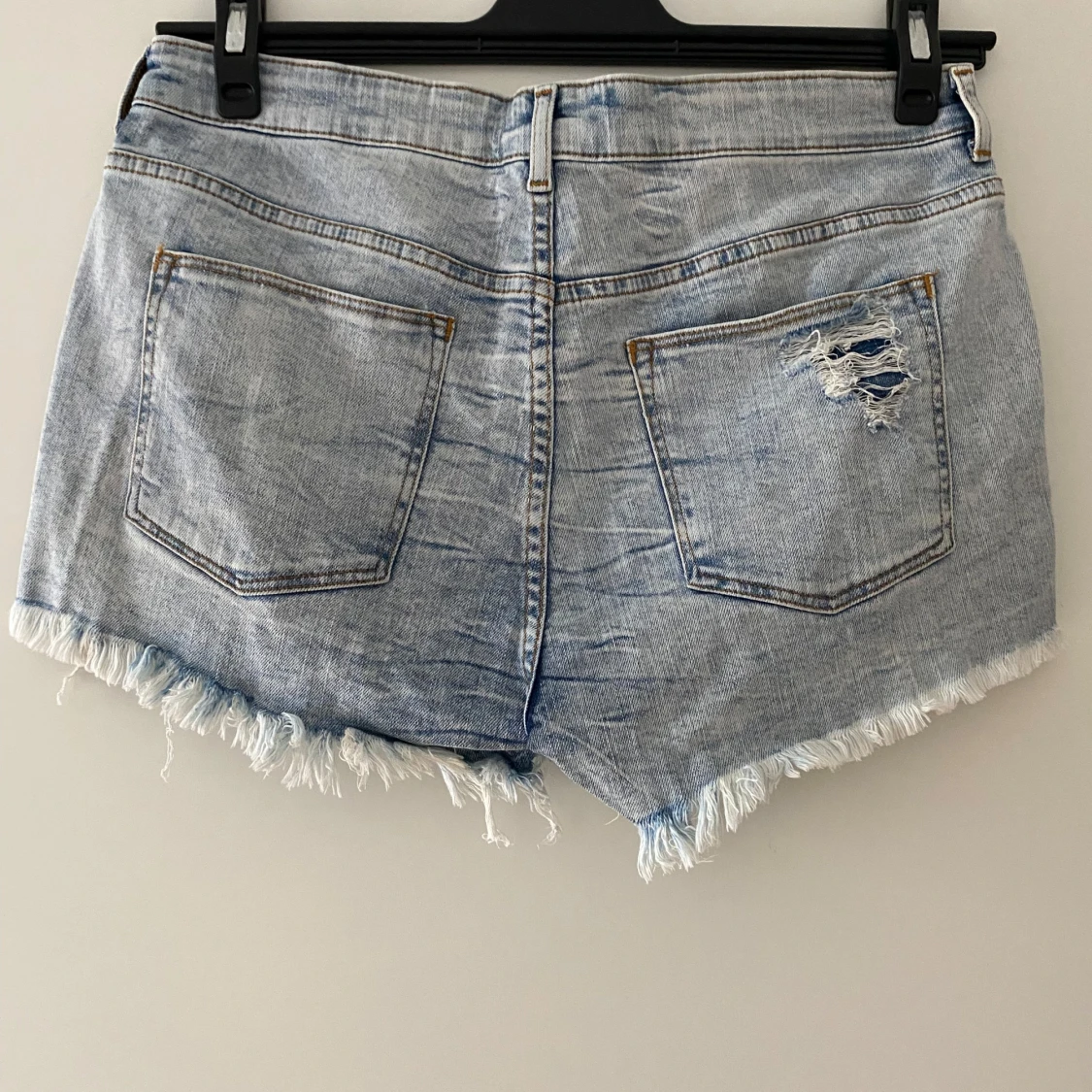 Ljusblå jeansshorts med slitningar och fransar - 1